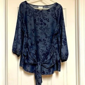 Women’s lightweight blouse with front tied belt.